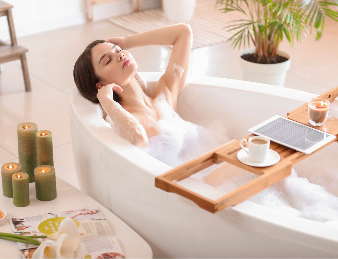 Female relaxing in bath tub filled with water and bath salts bath soak scented candles around the bath tub bathtub tray also placed infront of her